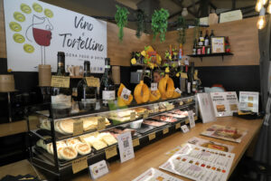 Detail of the Vino e Tortellino stall, Mercato Albinelli in Modena