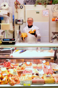 The La Polleria counter display at Mercato Albinelli in Modena