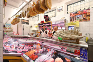 The Salumeria e Polleria Prandini counter display at Mercato Albinelli in Modena