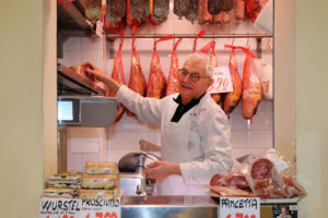 Produce from Salumeria Anselmo Bonini, Andrea Solieri, A. Facchini, deli and cured meats at Mercato Albinelli in Modena